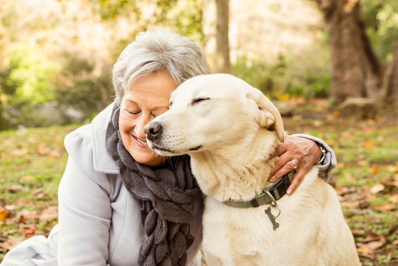 woman and dog hugging